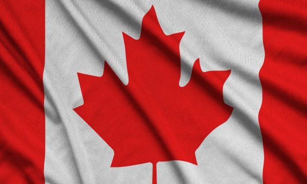 Canada flag  is depicted on a sports cloth fabric with many folds. Sport team waving banner